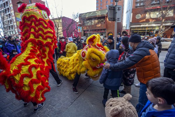 Jing Wo Cultural Assoication lion dance performers interact with children in the crowd during the Lunar New Year celebration in Chinatown on Sunday, February 6, 2022. ARYN TOOMBS / FOR LIVEWIRE CALGARY